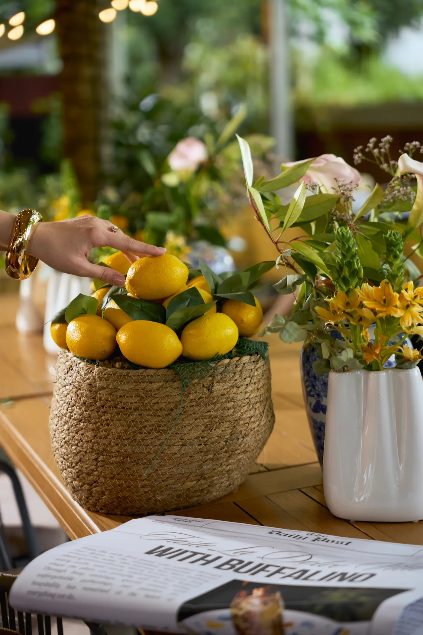 Table with lemons and flowers on the terrace